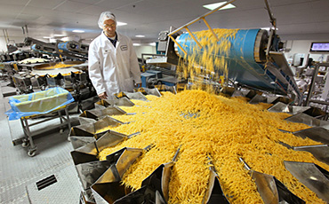 May 4, 2010 Photographs from Sargento in Plymouth WI.   Here William Bartnik, Plant Manager, looks over cheese shredding machines in action at the Plymouth plant. MICHAEL SEARS/MSEARS@JOURNALSENTINEL.COM